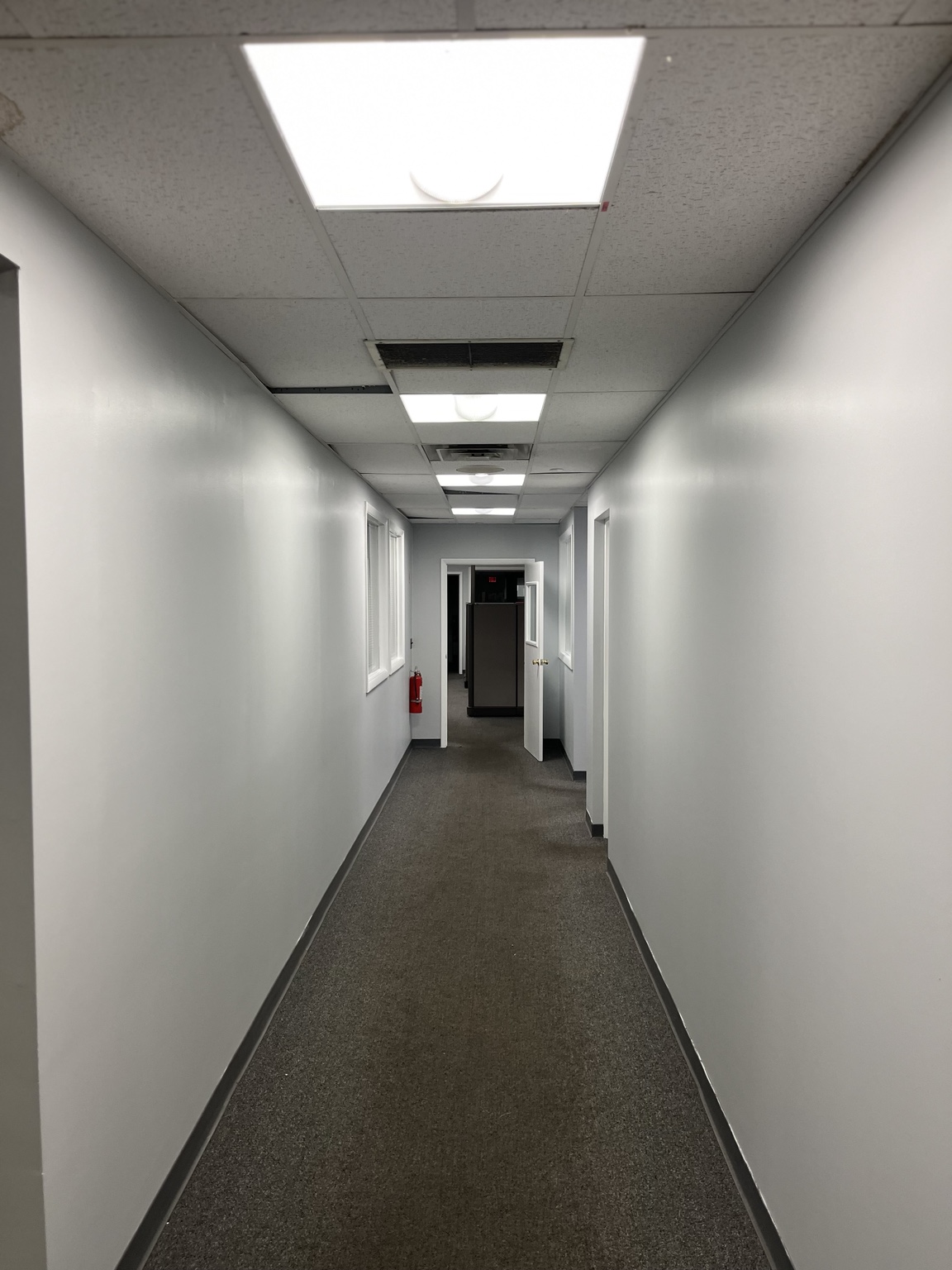 Freshly painted commercial hallway with clean gray walls and white trim